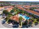 Scenic aerial view of community featuring pool, tennis court, clubhouse, and residences at 1149 S Beach Cir, Kissimmee, FL 34746