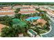 Community aerial view featuring a beautiful pool and tennis courts surrounded by lush landscaping at 1149 S Beach Cir, Kissimmee, FL 34746