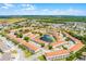 Beautiful aerial view of a townhome community with a central pond and lush landscaping at 1149 S Beach Cir, Kissimmee, FL 34746