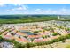 Expansive aerial view of the residential community, showcasing the pool and surrounding landscape at 1149 S Beach Cir, Kissimmee, FL 34746