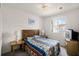 Relaxing bedroom with a queen bed, side tables, and a window offering natural light and a view at 1149 S Beach Cir, Kissimmee, FL 34746