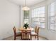 Bright dining area with a round table set by large windows, creating a cozy breakfast nook at 1149 S Beach Cir, Kissimmee, FL 34746
