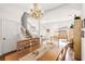 Well-lit dining area with hardwood floors, bright chandelier, stairway and sliding glass doors to a patio area at 1149 S Beach Cir, Kissimmee, FL 34746