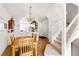 An open dining area showcases hardwood floors, a charming chandelier and an adjacent kitchen and stairway at 1149 S Beach Cir, Kissimmee, FL 34746