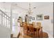 An open dining area showcases hardwood floors, a charming chandelier and an adjacent living area and stairway at 1149 S Beach Cir, Kissimmee, FL 34746