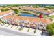 Townhomes with colorful facades and a red pin highlighting the location by the lake at 1149 S Beach Cir, Kissimmee, FL 34746