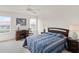 Spacious main bedroom with a ceiling fan, large windows, and a desk area, offering comfort and functionality at 1149 S Beach Cir, Kissimmee, FL 34746