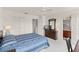 Well-lit main bedroom with a ceiling fan and closet space, leading to the en-suite bathroom for convenience at 1149 S Beach Cir, Kissimmee, FL 34746