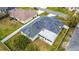 Aerial view of house displaying solar panels and a screened in back porch at 1167 Saint Tropez Ct, Kissimmee, FL 34759