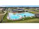 An aerial view showing the community pool with lounge chairs and a clubhouse at 1167 Saint Tropez Ct, Kissimmee, FL 34759