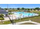 View of the community pool with a slide, lounge chairs, and well-maintained grounds at 1167 Saint Tropez Ct, Kissimmee, FL 34759