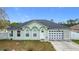 Charming single-story home featuring a unique garage door and manicured front lawn at 1167 Saint Tropez Ct, Kissimmee, FL 34759
