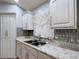Charming kitchen features a stainless steel sink and granite countertops at 1167 Saint Tropez Ct, Kissimmee, FL 34759