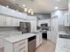 Modern kitchen featuring stainless steel appliances, granite counters, and a stylish island at 1167 Saint Tropez Ct, Kissimmee, FL 34759