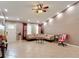 Inviting living room featuring tiled floors, a ceiling fan, and ample natural light at 1167 Saint Tropez Ct, Kissimmee, FL 34759