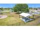 Community picnic shelter with tables, waste can, and lush landscaping near playground in a well maintained community at 1167 Saint Tropez Ct, Kissimmee, FL 34759