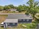 View of a charming gray home featuring a large lot and mature trees at 1226 Pine St, Orlando, FL 32824