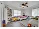 Bright bedroom features hardwood floors, ceiling fan, and shelving for toys and decor at 1226 Pine St, Orlando, FL 32824