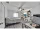Bright bedroom features wood flooring, a ceiling fan, and ample storage with built-in shelves at 1226 Pine St, Orlando, FL 32824
