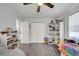 Spacious bedroom with hardwood floors, ceiling fan, shelving, and ample storage space at 1226 Pine St, Orlando, FL 32824
