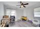 Bedroom features hardwood floors, ceiling fan, natural light and designated pet area with accessories at 1226 Pine St, Orlando, FL 32824