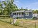 Charming single-story home with a cozy front porch, lush green lawn, and fenced yard at 1226 Pine St, Orlando, FL 32824