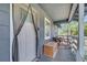 Welcoming front porch with wooden deck, with a white mesh screen, ideal for outdoor relaxation at 1226 Pine St, Orlando, FL 32824