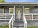 Close-up of the home's inviting front porch, entry, and well-kept stairs at 1226 Pine St, Orlando, FL 32824