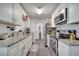 Bright kitchen with white cabinets, granite countertops, and stainless steel appliances at 1226 Pine St, Orlando, FL 32824