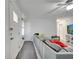 Open-concept living room featuring modern gray flooring, neutral walls, and a large comfortable sectional sofa at 1226 Pine St, Orlando, FL 32824