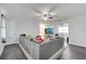 Spacious living room with a comfortable sectional sofa, fan, and stylish gray flooring, perfect for relaxation at 1226 Pine St, Orlando, FL 32824