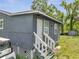 Features rear entrance with steps to door and car parked on the side of the house at 1226 Pine St, Orlando, FL 32824