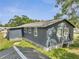 Exterior view shows rear of home with fenced in yard and room to expand at 1226 Pine St, Orlando, FL 32824