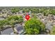 Aerial shot of a home in a lush neighborhood with well-maintained lawns and tree-lined streets at 1345 Tindaro Dr, Apopka, FL 32703