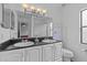 Bright bathroom with double sinks, a large mirror, and a walk-in shower at 1345 Tindaro Dr, Apopka, FL 32703