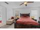 Spacious bedroom features a large bed, side table, and a comfortable lounge chair at 1345 Tindaro Dr, Apopka, FL 32703