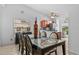 Open dining area with glass table, leading to a bright kitchen with stainless appliances at 1345 Tindaro Dr, Apopka, FL 32703