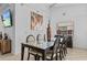 Bright dining room featuring glass-top table, six chairs, and modern artwork at 1345 Tindaro Dr, Apopka, FL 32703