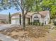 Single-story home with manicured landscaping, arched window, and two-car garage at 1345 Tindaro Dr, Apopka, FL 32703