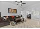 Open-concept living room showcasing a comfortable sofa and neutral tile floors at 1345 Tindaro Dr, Apopka, FL 32703