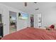 Bedroom with TV, closet, and bathroom entrance, offering a private retreat at 1345 Tindaro Dr, Apopka, FL 32703