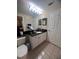 Bathroom featuring a granite countertop vanity, tiled floor, and modern lighting at 14341 Fredricksburg Dr # 1016, Orlando, FL 32837