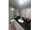 Bathroom featuring modern fixtures, granite countertop, and a glass-enclosed shower at 14341 Fredricksburg Dr # 1016, Orlando, FL 32837