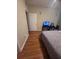 Bedroom showcases a cozy atmosphere with neutral walls, hardwood floors, and a nice bed at 14341 Fredricksburg Dr # 1016, Orlando, FL 32837