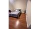 Bedroom features wood flooring, a comfortable bed, and a cozy atmosphere at 14341 Fredricksburg Dr # 1016, Orlando, FL 32837