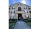 Attractive three-story condo building with well-manicured landscaping and elegant architectural details at 14341 Fredricksburg Dr # 1016, Orlando, FL 32837
