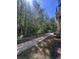 Exterior view featuring a fenced-in sidewalk with lots of trees at 14341 Fredricksburg Dr # 1016, Orlando, FL 32837