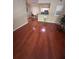 Open living area with gleaming hardwood floors, neutral paint, seamlessly flowing into the dining and kitchen areas at 14341 Fredricksburg Dr # 1016, Orlando, FL 32837
