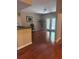Bright living room with hardwood floors, offering access to a porch via glass doors, and views of kitchen at 14341 Fredricksburg Dr # 1016, Orlando, FL 32837