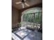 Screened porch offering an outdoor retreat, featuring tiled flooring and serene views of the surrounding greenery at 14341 Fredricksburg Dr # 1016, Orlando, FL 32837